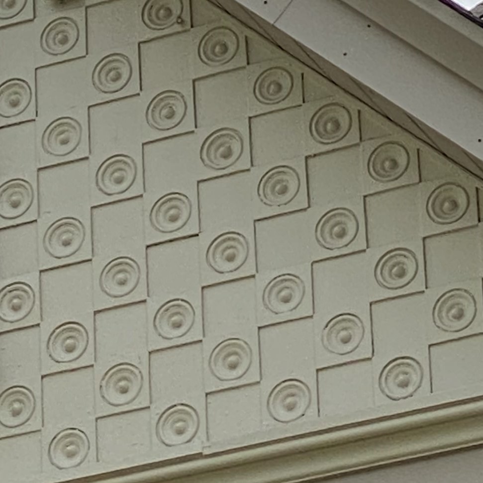 architectural detail with pattern of connected squares with circles inside